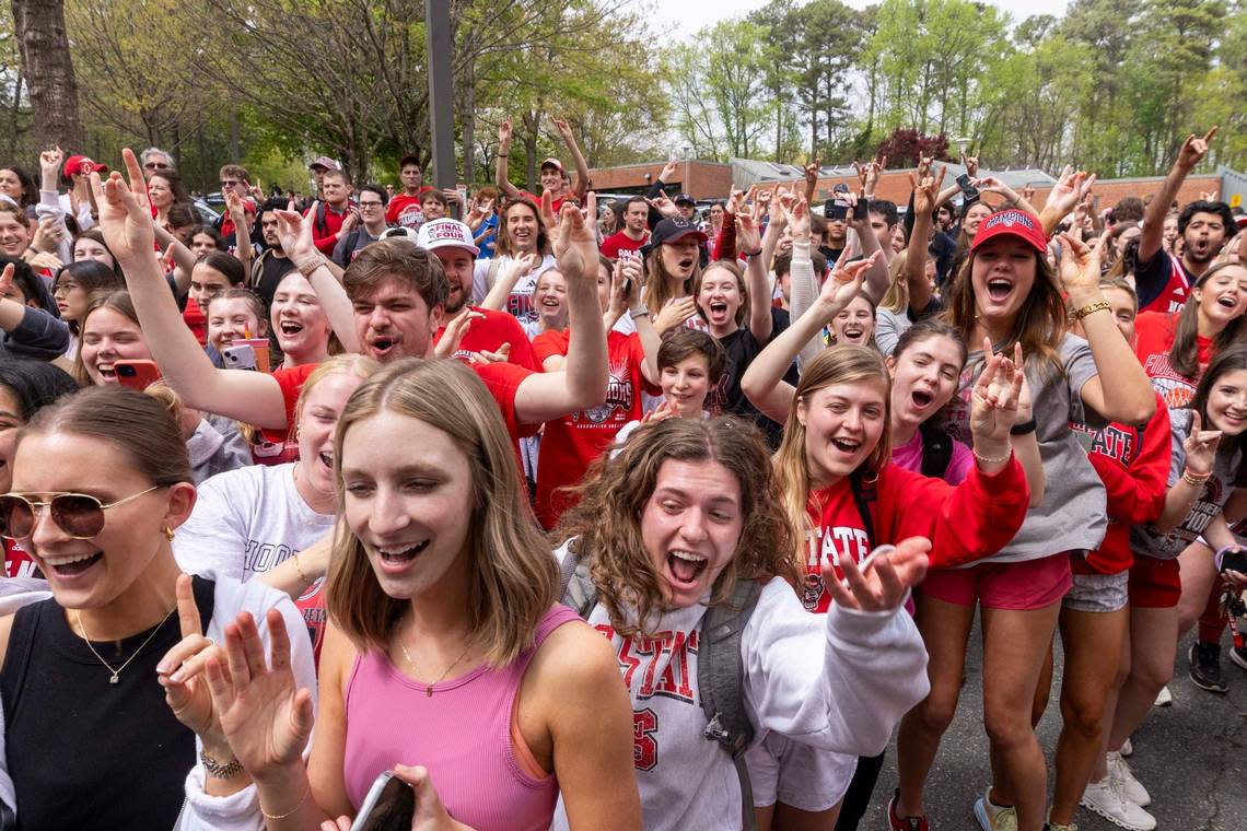 NC.State fans cheer as a bus carrying the men’s basketball team departs campus Wednesday, April 3, 2024. The team is headed to the Final Four for the first time since 1983.