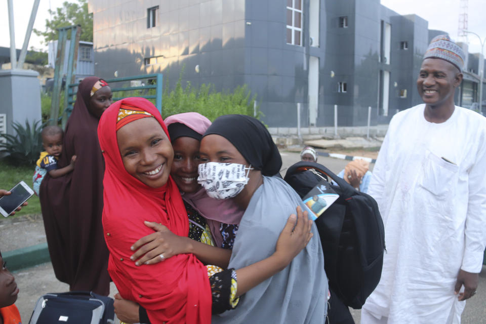 A woman welcomes her daughter who was evacuated from Sudan upon her arrival at the Nnamdi Azikiwe International Airport in Abuja, Nigeria, Friday, May 5, 2023. Many Africans escaping the conflict in Sudan that erupted with little warning last month faced a long wait - three weeks for some - to get out and severe challenges on the way as their governments stuggled to mobilize resources. (AP Photo/Gbemiga Olamikan)