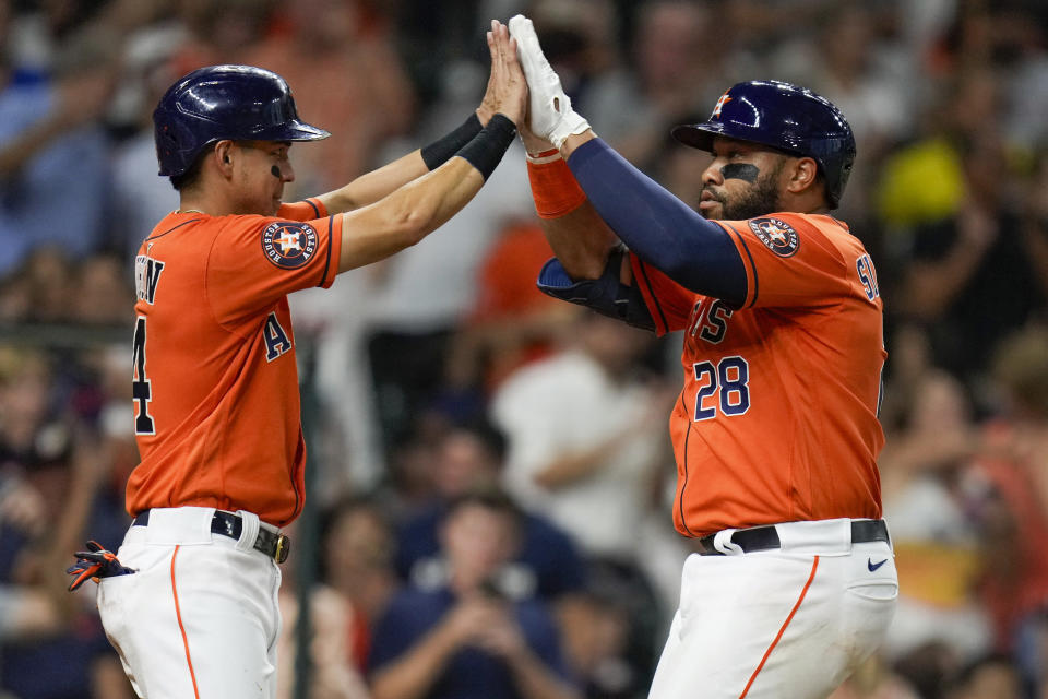 Houston Astros' Jon Singleton, right, celebrates his two-run home run against the Los Angeles Angels with Mauricio Dubon during the third inning of a baseball game Friday, Aug. 11, 2023, in Houston. (AP Photo/Eric Christian Smith)