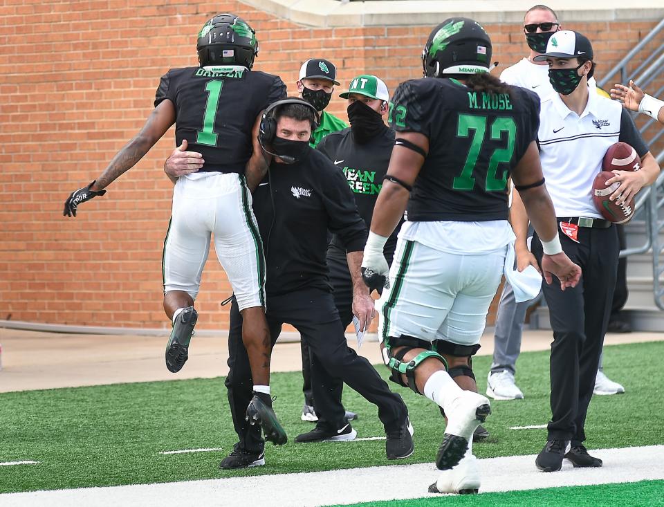 North Texas head coach Seth Litrell picks up wide receiver Jaelon Darden (1) after Darden scored a touchdown against Rice on Saturday, Nov. 21, 2020, in Denton, Texas. (Al Key/The Denton Record-Chronicle via AP)