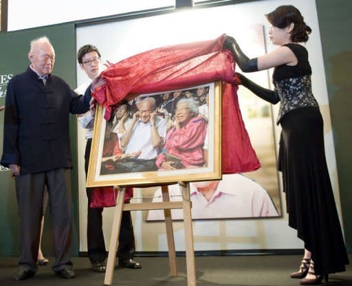 Singapore's Minister Mentor Lee Kuan Yew unveils a photograph of himself and his late wife Kwa Geok Choo