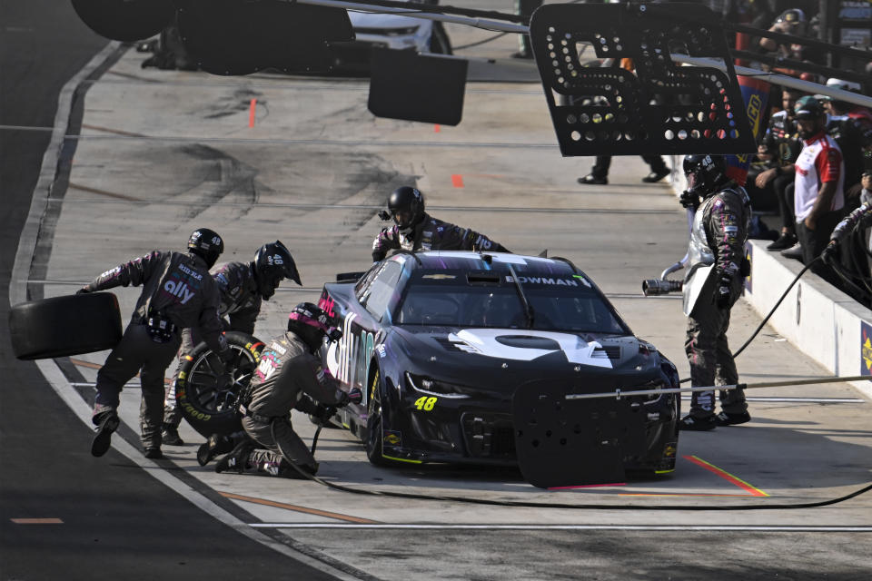 The pit crew of Josh Berry (48) rushes to complete a pit stop during the NASCAR All-Star Open Cup Series auto race at North Wilkesboro Speedway, Sunday, May 21, 2023, in North Wilkesboro, N.C. (AP Photo/Matt Kelley)