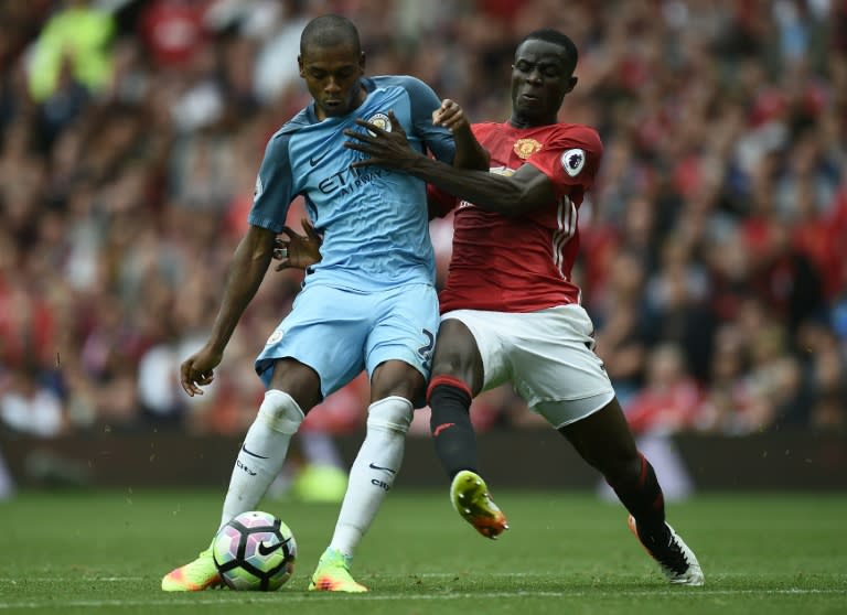 Manchester City's Fernandinho (L) fights for the ball with Manchester United's Eric Bailly during their English Premier League match, at Old Trafford, on September 10, 2016