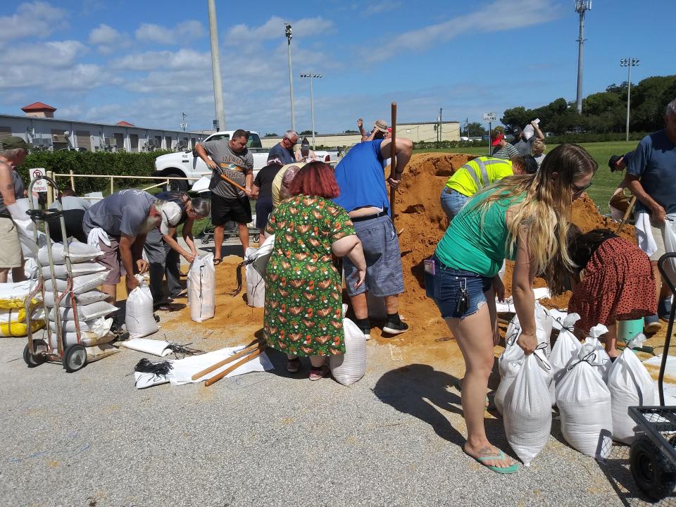 Residents fill sand bags at Reed Canal Park in South Daytona as preparations continue for Tropical Storm Ian.