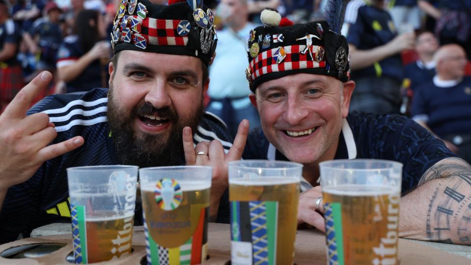 Two Scotland fans with pints of beer 