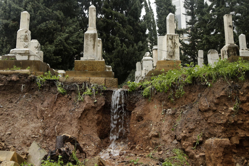 CORRECTS TO CAPITAL'S ONLY JEWISH CEMETERY, NOT COUNTRY'S - Graves in a Jewish cemetery sit damaged from heavy rains in the Sodeco area of Beirut, Lebanon, Thursday, Dec. 26, 2019. A heavy storm hit Lebanon with heavy rain and strong winds causing an old wall to collapse in the capital's only Jewish cemetery, causing damage to several tombstones. Lebanon once had a thriving Jewish community, but the various Arab-Israeli wars and Lebanon's own 1975-90 civil war caused waves of emigration and almost none are left in the country today. (AP Photo/Hassan Ammar)