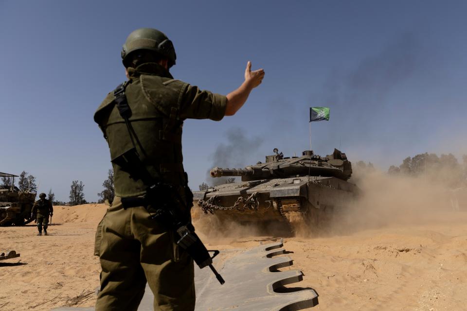 An Israeli soldier directs a tank near the border with the southern Gaza Strip on May 5, 2024.