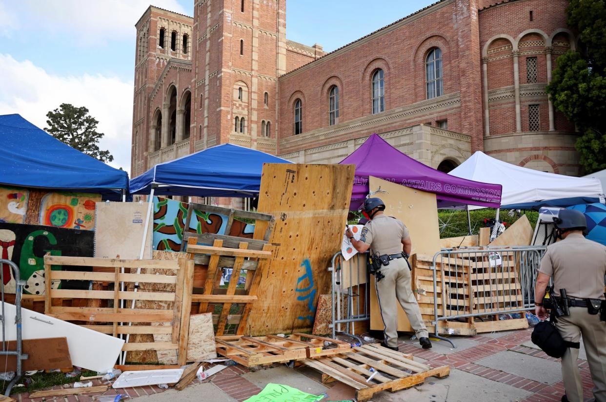 <span>California highway patrol officers at a pro-Palestinian encampment on UCLA’s campus on 1 May 2024.</span><span>Photograph: Mario Tama/Getty Images</span>