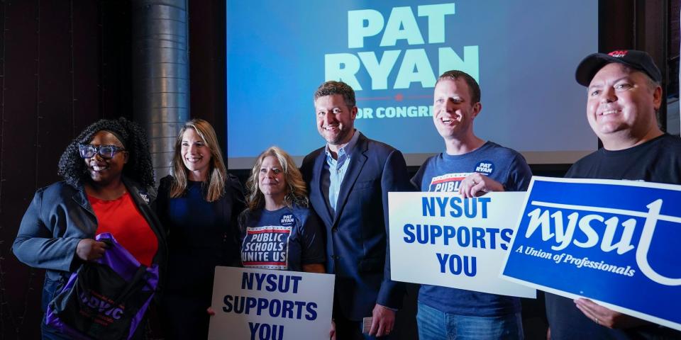 Democratic candidate Pat Ryan poses for a photo with supporters during a campaign rally for Ryan, Monday, Aug. 22, 2022, in Kingston, N.Y.