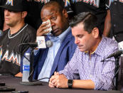 <p>Michael Hill, Marlins president of baseball operations, wipes his tears during a press conference to announce the death of Marlins pitcher Jose Fernandez. Fernandez, the ace right-hander for the Miami Marlins who escaped Cuba to become one of baseball’s brightest stars, was killed in a boating accident early Sunday morning. Fernandez was 24. (AP Photo/Gaston De Cardenas) </p>