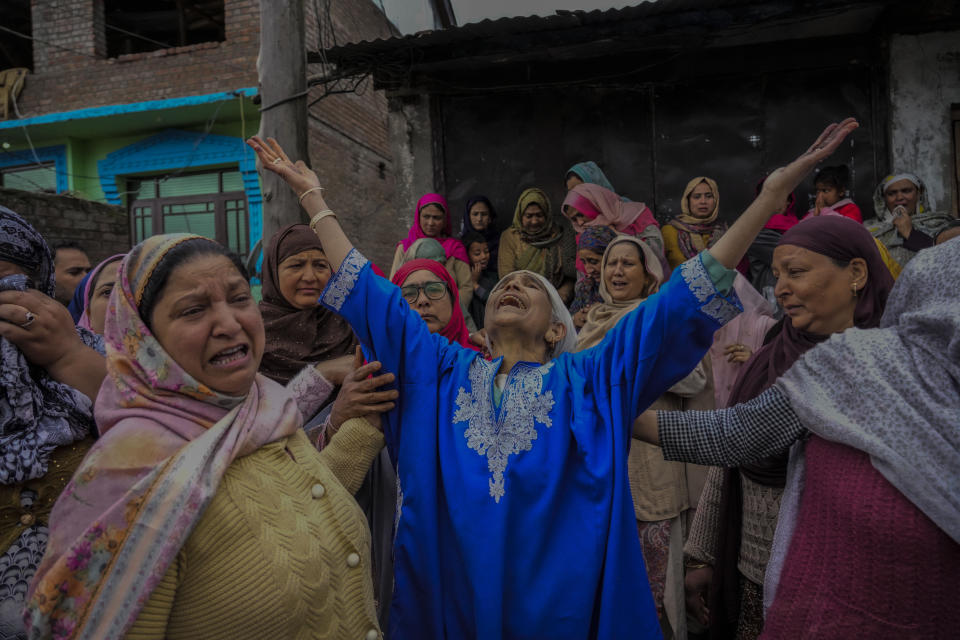 Family members and relatives cry after a boat carrying people including children capsized in Jhelum river on the outskirts of Srinagar, Indian controlled Kashmir, Tuesday, April. 16, 2024. Rescue operation is continuing for the several missing people. (AP Photo/Mukhtar Khan)