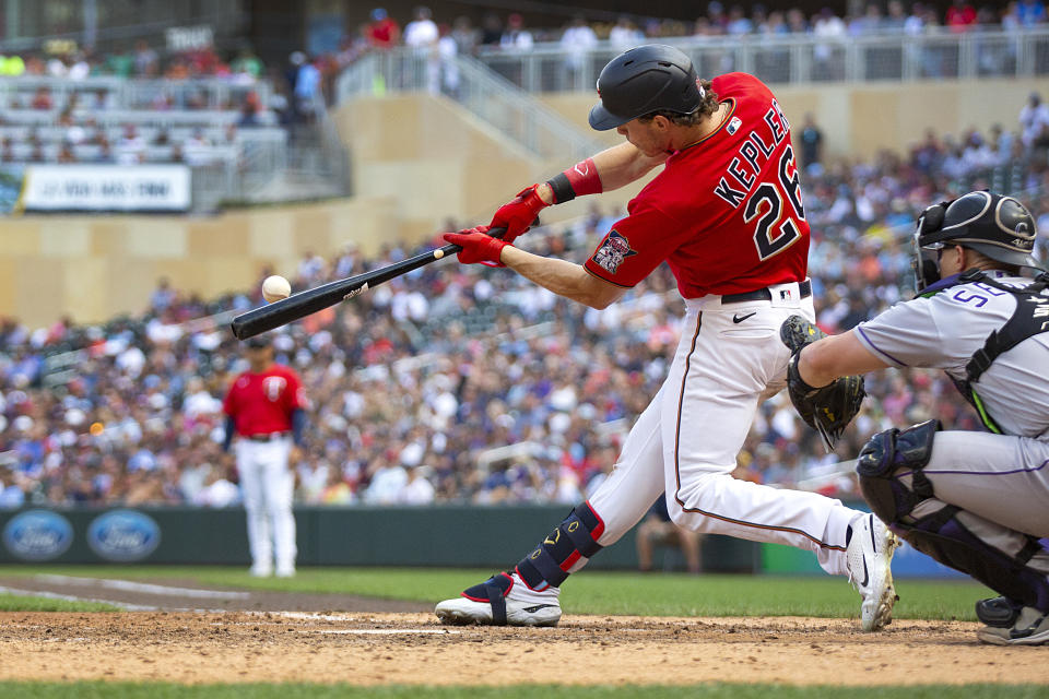 Minnesota Twins' Max Kepler hits an RBI-double against the Colorado Rockies in the seventh inning of a baseball game Sunday, June 26, 2022, in Minneapolis. (AP Photo/Andy Clayton-King)