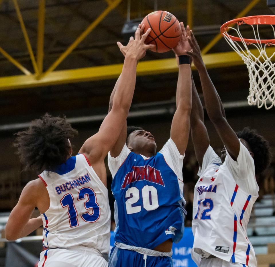 Junior All-Star Myles Colvin (20) attempts a lay-up against Indiana All-Stars Javon Buchanan (13) and Jaxon Edwards (12) on Wednesday, June 8, 2022, at Mt. Vernon High School in Fortville.