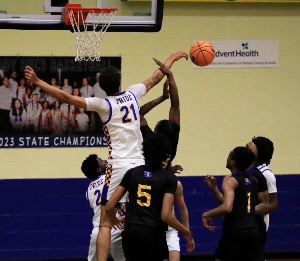 Mainland’s DeAndre Newland (21) blocks a Rickards shot in the Region 1-5A finals on Friday, Feb. 23, 2024 at Mainland High School.