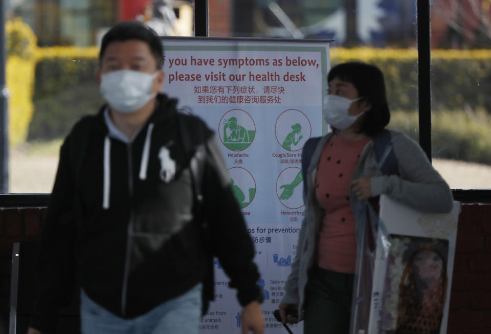 Passengers wearing face masks arrive at Tribhuwan International airport in Kathmandu, Nepal, Tuesday, Jan. 28, 2020. Authorities have started screening passengers after one confirmed case of a new coronavirus infection was detected in the Himalayan country. (AP Photo/Niranjan Shrestha)