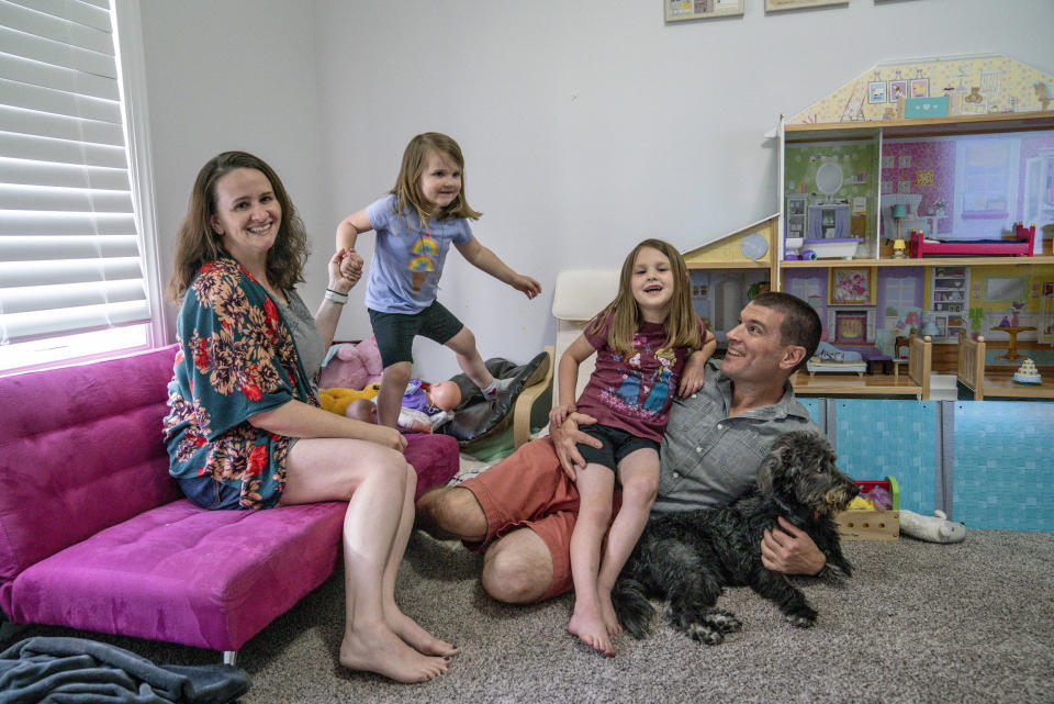 Annie Whitlock and her husband Mike at home with their daughters McKenzie and Maggie. (Sarah Rice / for NBC News)