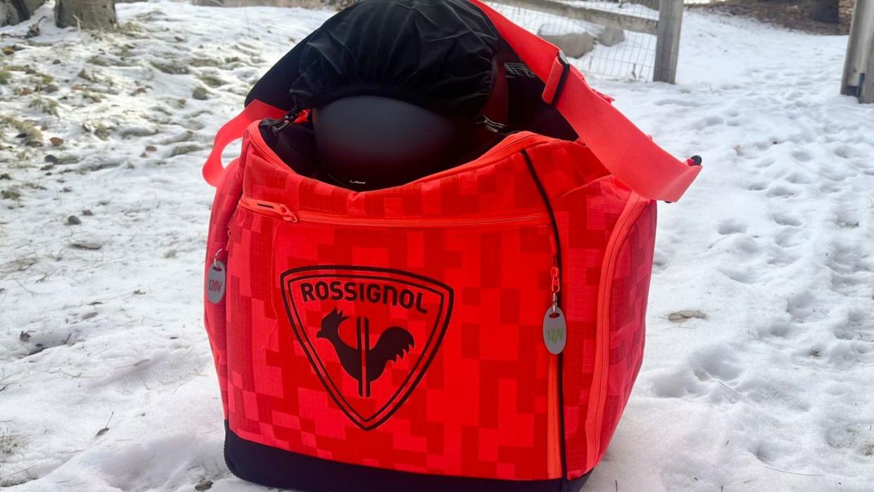 a red ski boot bag on a snowy surface