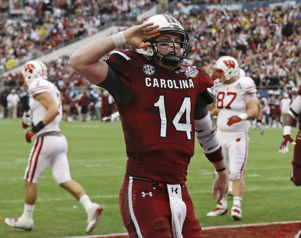 South Carolina quarterback Connor Shaw (14) salutes towards fans after catching a touchdown on a pass from receiver Bruce Ellington during the first half of the Capital One Bowl NCAA college football game against Wisconsin in Orlando, Fla., Wednesday, Jan. 1, 2014.(AP Photo/John Raoux)