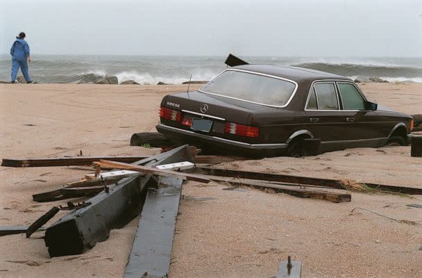 PHOTO: In this July 12, 1996, file photo, a car lies buried in the sand on Canal Drive in Carolina Beach, N.C., after Hurricane Bertha passed through the area. The car is on what was earlier a paved street. (Fayetteville Observer-Times via AP, FILE)