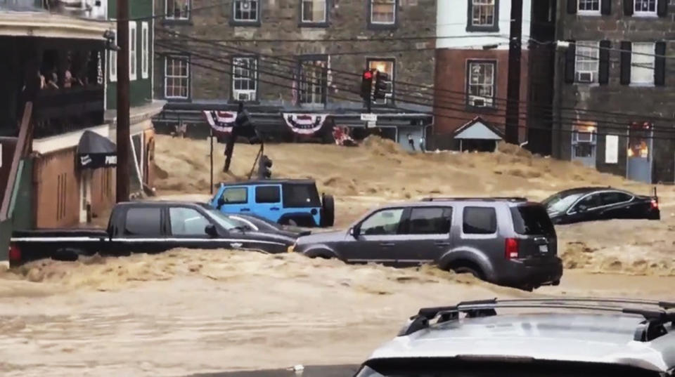 <p>Water rushes through Main Street in Old Ellicott City. (Screen grab: Libby Solomon, Baltimore Sun via AP) </p>