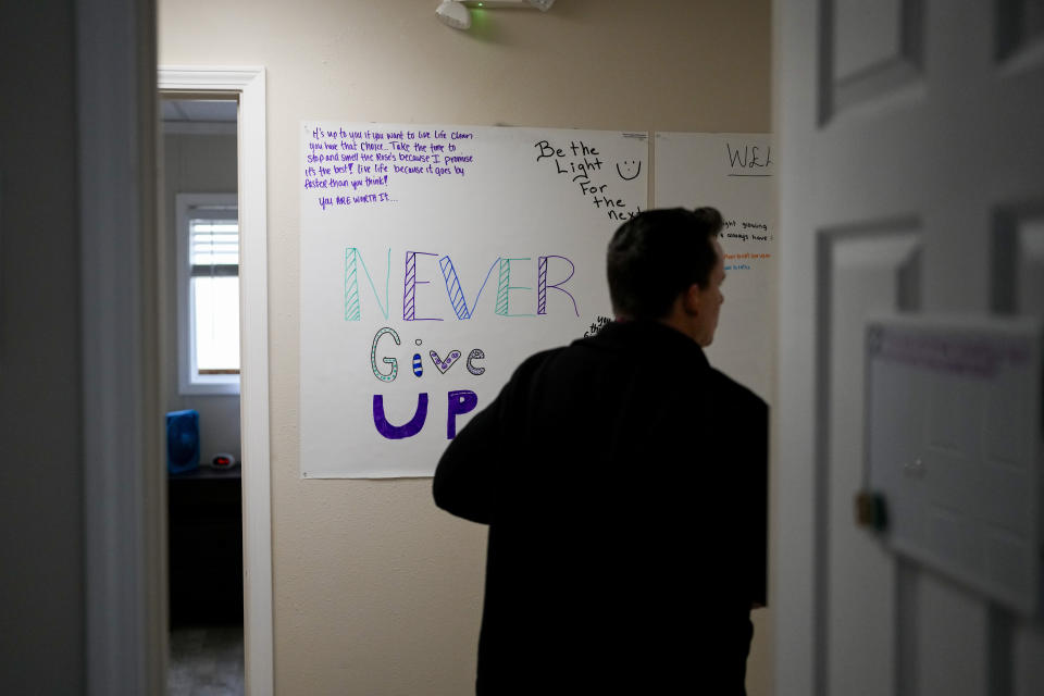 Dr. Jesse Davis, of the Lummi Healing Spirit opioid treatment program, walks by a sign with encouraging messages at their seven-bed facility on the Lummi Reservation, Thursday, Feb. 8, 2024, near Bellingham, Wash. Washington State tribal leaders are urging state lawmakers to pass a bill that would send at least $7.75 million in funding to tribal nations to help them stem a dramatic rise in opioid overdose deaths. (AP Photo/Lindsey Wasson)
