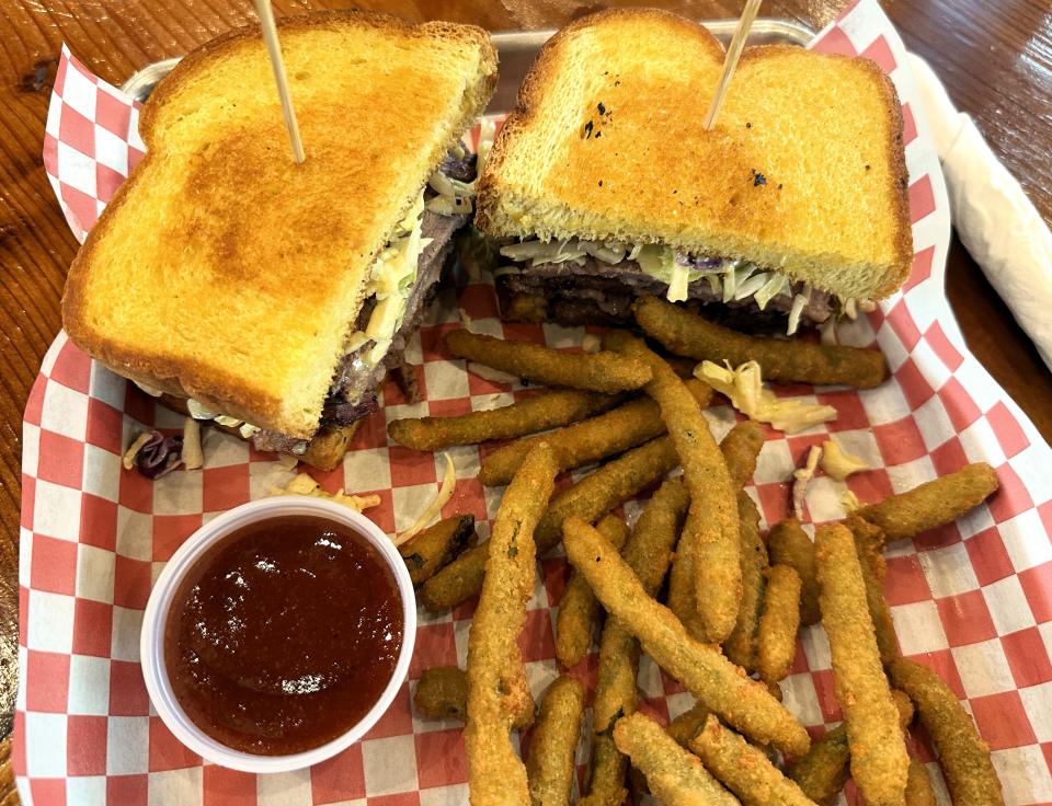 A smoked brisket sandwich on grilled Texas Toast with fried green beans await a diner at the Old Mill Eatery & Smokehouse in Shasta Lake.