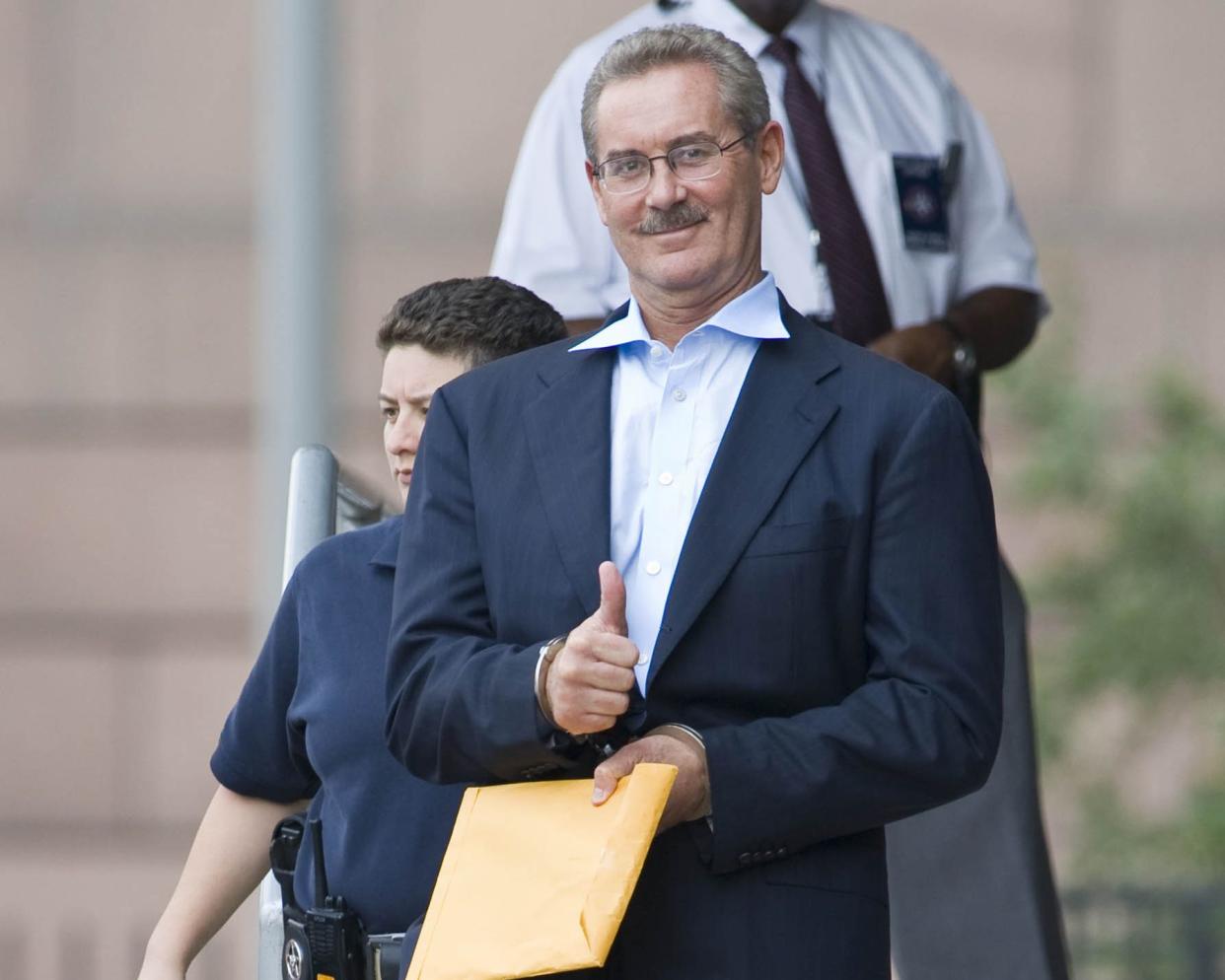 Stanford Financial chairman and CEO Sir Robert Allen Stanford (R) gestures as he leaves the Bob Casey Federal Courthouse after a bond appeal hearing June 29, 2009 in Houston, Texas.