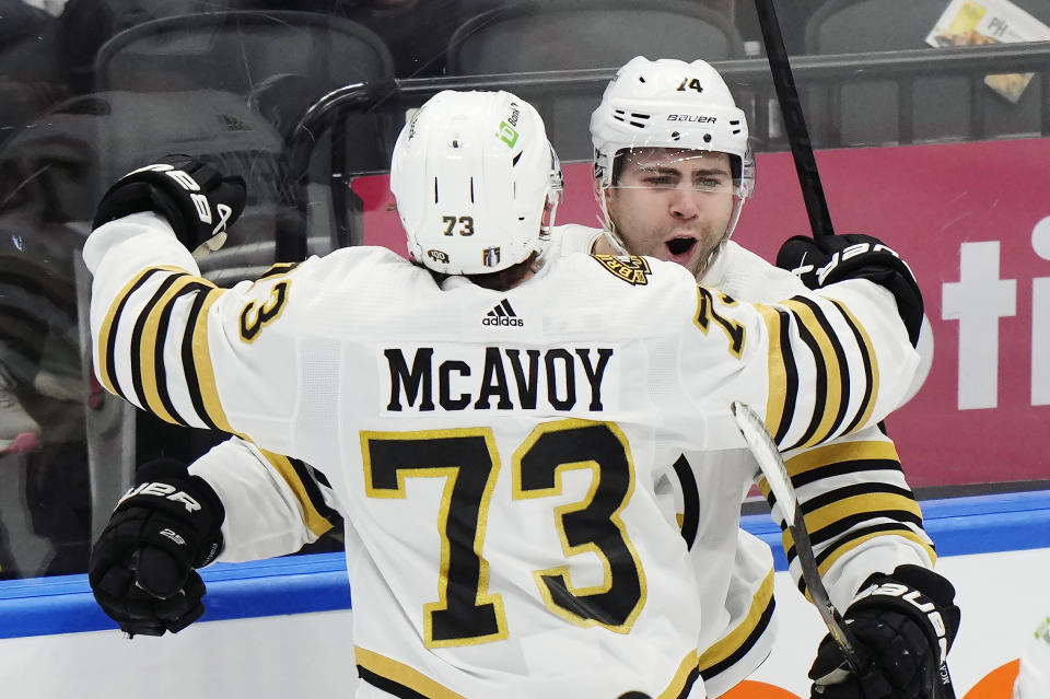 Boston Bruins' Jake DeBrusk (74) celebrates his goal against the Toronto Maple Leafs with Charlie McAvoy (73) during the third period of action in Game 3 of an NHL hockey Stanley Cup first-round playoff series in Toronto on Wednesday, April 24, 2024. (Frank Gunn/The Canadian Press via AP)