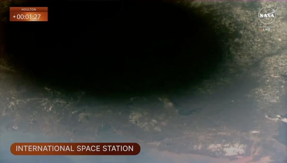 screengrab of the view from space shows moon's shadow on earth land
