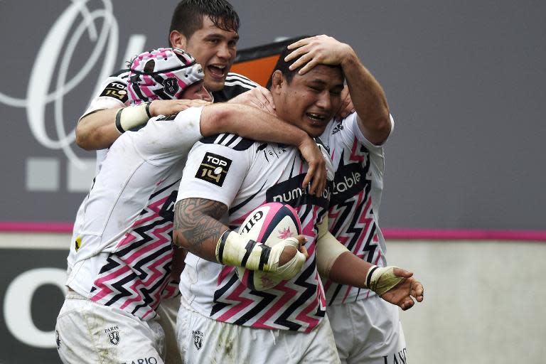 Stade Francais Paris' Samoan prop Sakaria Taulafo (C) celebrates with teammates after scoring a try during their French Top 14 rugby match against Clermont, at Jean Bouin stadium in Paris, on March 28, 2015