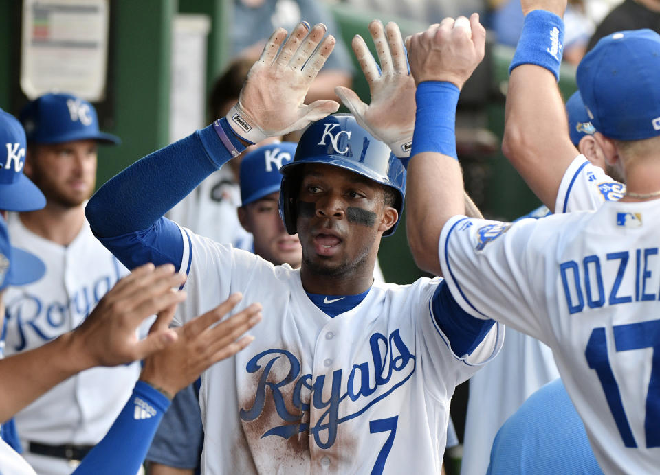 Kansas City Royals' Rosell Herrera (7) is congratulated by teammates after scoring on a Salvador Perez single during the third inning against the Detroit Tigers in a baseball game Tuesday, July 24, 2018, in Kansas City, Mo. (AP Photo/Ed Zurga)