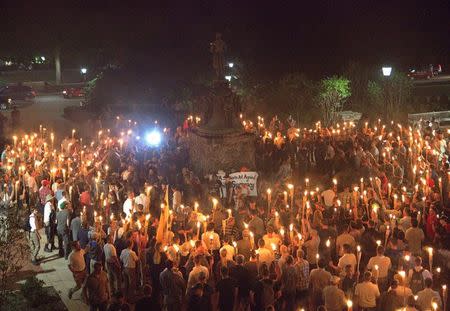 White nationalists carry torches around a statue of Thomas Jefferson on the grounds of the University of Virginia, on the eve of a planned Unite The Right rally in Charlottesville, Virginia, U.S. August 11, 2017. Alejandro Alvarez/News2Share via REUTERS
