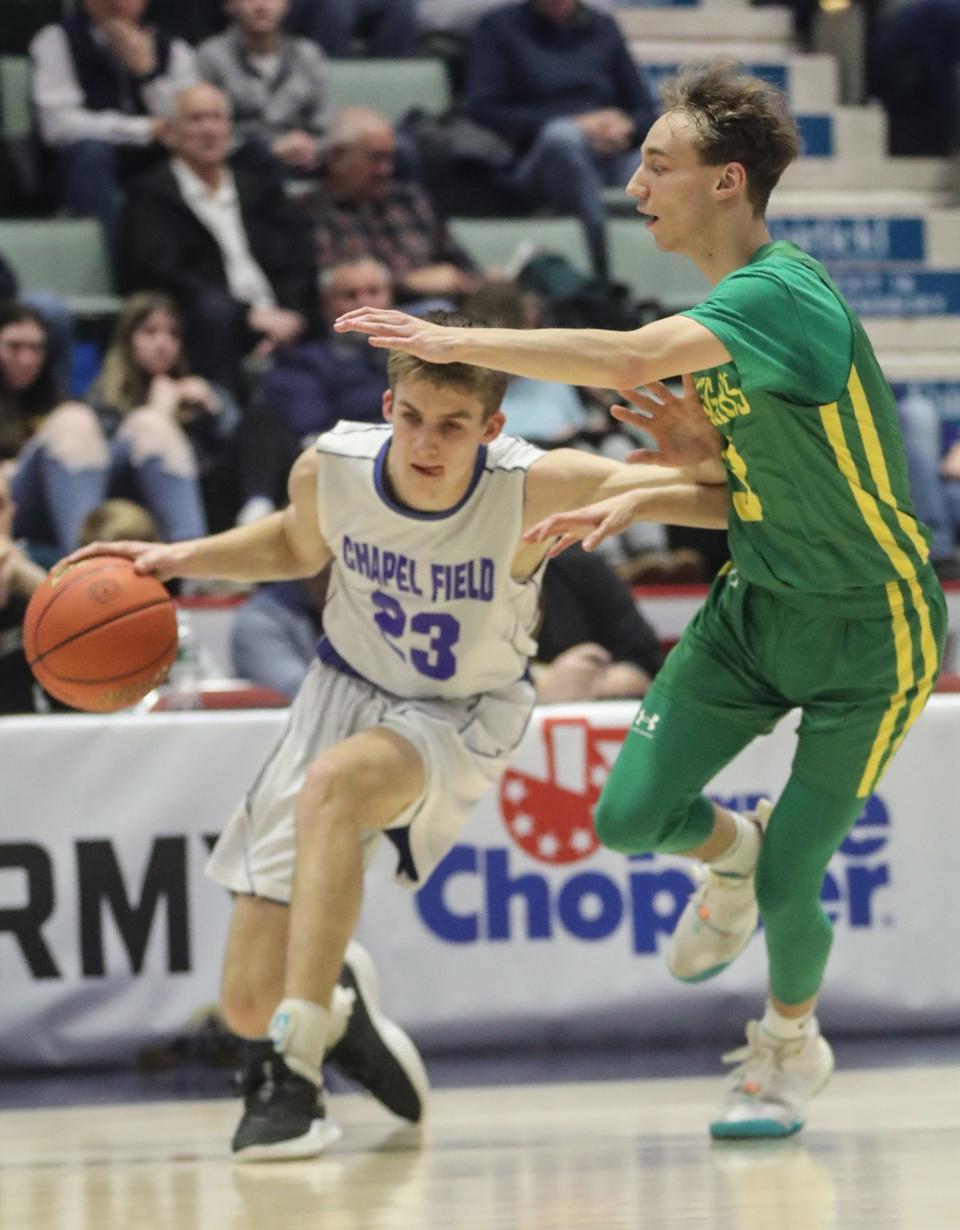 Noah Stewart of Chapel Field drives past Zach Hopper of North Warren during a NYSPHSAA Class D semifinal basketball game at the Cool Insuring Arena in Glens Falls March 18, 2023.