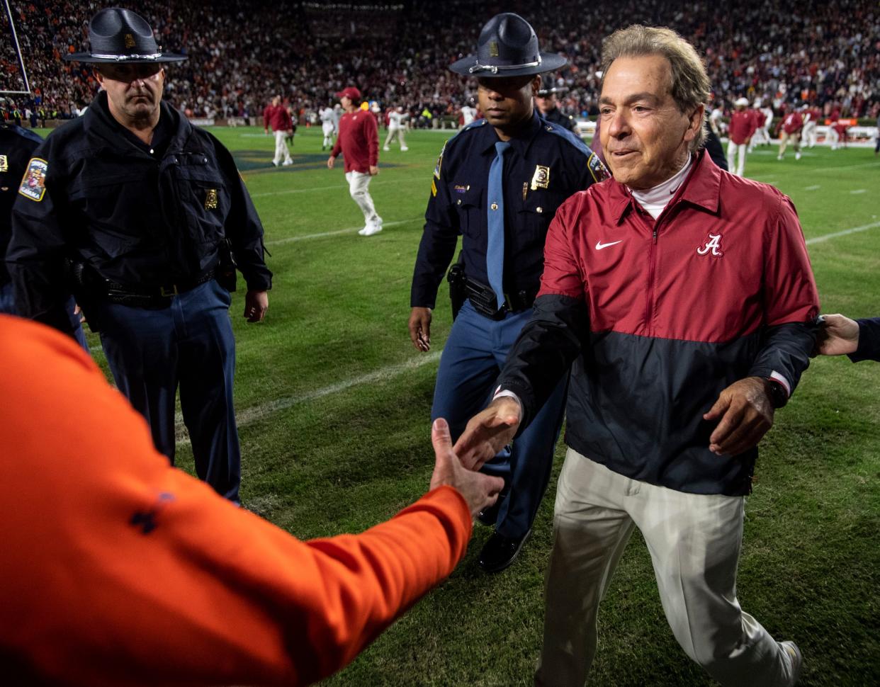 Auburn Tigers head coach Bryan Harsin and Alabama Crimson Tide head coach Nick Saban shake hands after the game during the Iron Bowl at Jordan-Hare Stadium in Auburn, Ala., on Saturday, Nov. 27, 2021. Alabama Crimson Tide defeated Auburn Tigers 24-22 in 4OT.