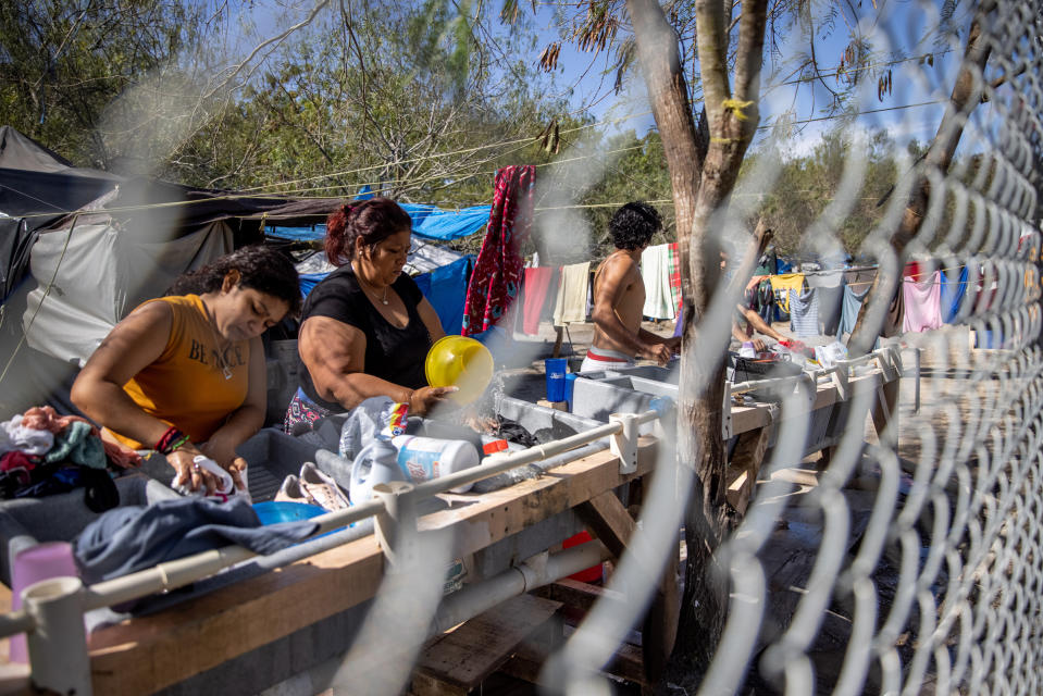 Asylum seekers washing clothing inside a camp in Matamoros, Mexico on Feb. 7, 2021.<span class="copyright">John Moore—Getty Images</span>