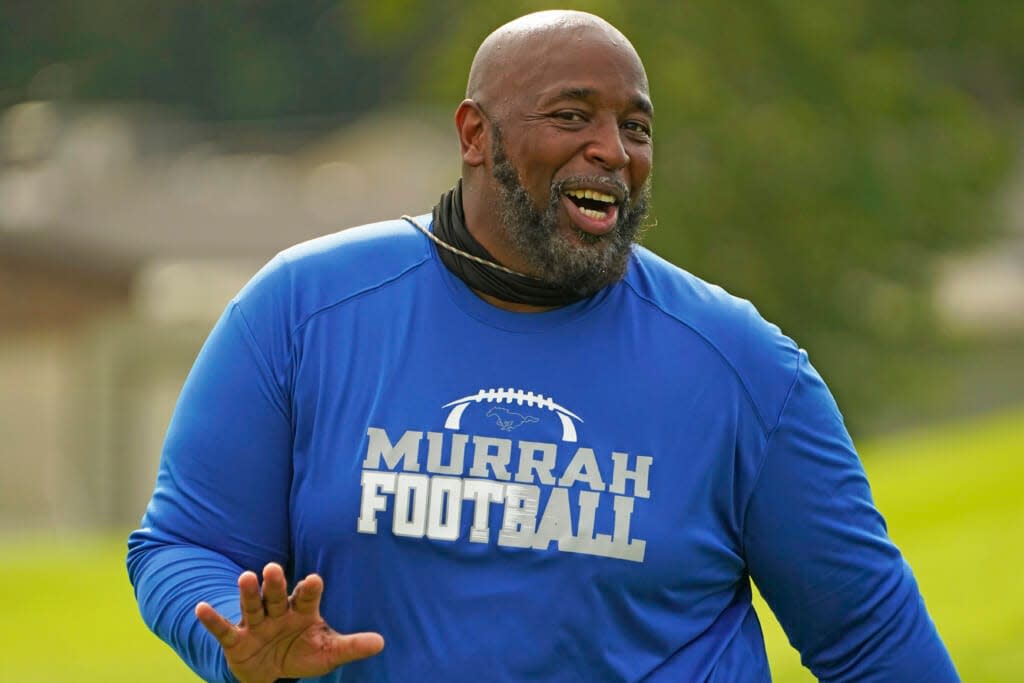 Murrah High School football coach Marcus Gibson encourages his players during practice, Wednesday, Aug. 31, 2022, in Jackson, Miss. (AP Photo/Rogelio V. Solis)
