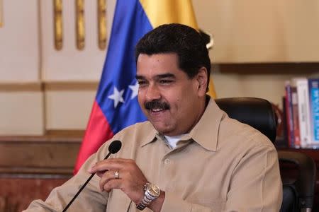 Venezuela's President Nicolas Maduro smiles as he speaks during a meeting with ministers and members of the military high command at the Miraflores Palace in Caracas, Venezuela April 18, 2017. Miraflores Palace/Handout via REUTERS