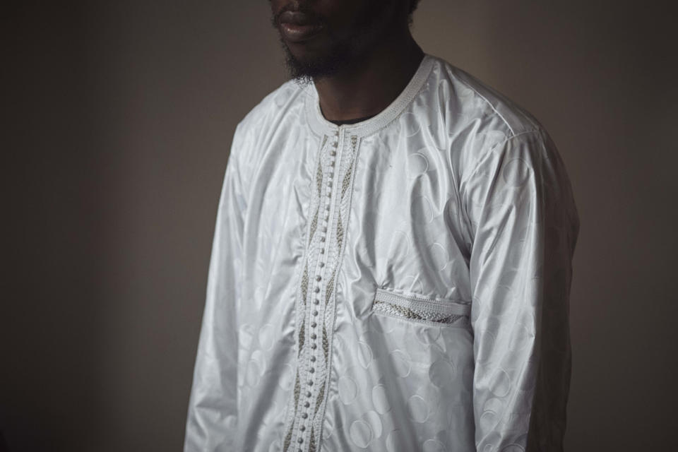 Abdoul, 32 year-old migrant from Maghama, Mauritania poses for a photograph at his shared apartment on Friday, Oct. 6, 2023, in New York. Abdoul traveled from Mauritania to New York via Istanbul, Bogota, El Salvador, Nicaragua, Honduras, Guatemala, Mexico and crossed the U.S. southern border in Texas on July 4, 2023. Abdoul is one of more than 8,000 migrants who have been jailed on criminal trespassing charges at the Texas border since Gov. Greg Abbott began authorizing the arrests in 2021. (AP Photo/Andres Kudacki)