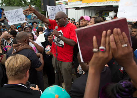Community members attend a vigil in memory of Alton Sterling at the Triple S Food Mart in Baton Rouge, Louisiana, July 6, 2016. REUTERS/Jeffrey Dubinsky
