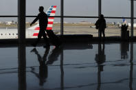 Passengers make their way through the terminal at Indianapolis International Airport in Indianapolis, Wednesday, Nov. 21, 2018. The airline industry trade group Airlines for America expects that Wednesday will be the second busiest day of the holiday period behind only Sunday, when many travelers will be returning home after Thanksgiving.(AP Photo/Michael Conroy)