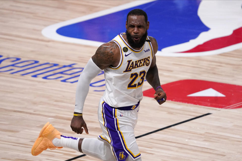 FILE -Los Angeles Lakers' LeBron James (23) celebrates during the second half in Game 6 of basketball's NBA Finals against Miami Heat Sunday, Oct. 11, 2020, in Lake Buena Vista, Fla. LeBron James is about to pass Kareem Abdul-Jabbar as the NBA's career scoring leader. The AP is looking back at some of his top games along the way. (AP Photo/Mark J. Terrill, File)