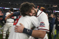 Atlanta Braves shortstop Dansby Swanson, right, hugs Atlanta Braves' Eddie Rosario after winning Game 6 of baseball's National League Championship Series against the Los Angeles Dodgers Sunday, Oct. 24, 2021, in Atlanta. The Braves defeated the Dodgers 4-2 to win the series. (AP Photo/Brynn Anderson)