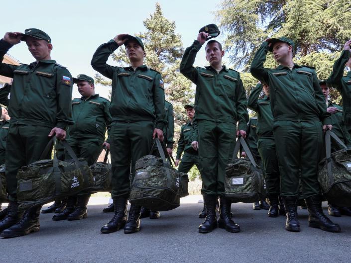 Russian conscripts called up for military service line up before their departure for garrisons as they gather at a recruitment centre in Simferopol, Crimea, April 25, 2023