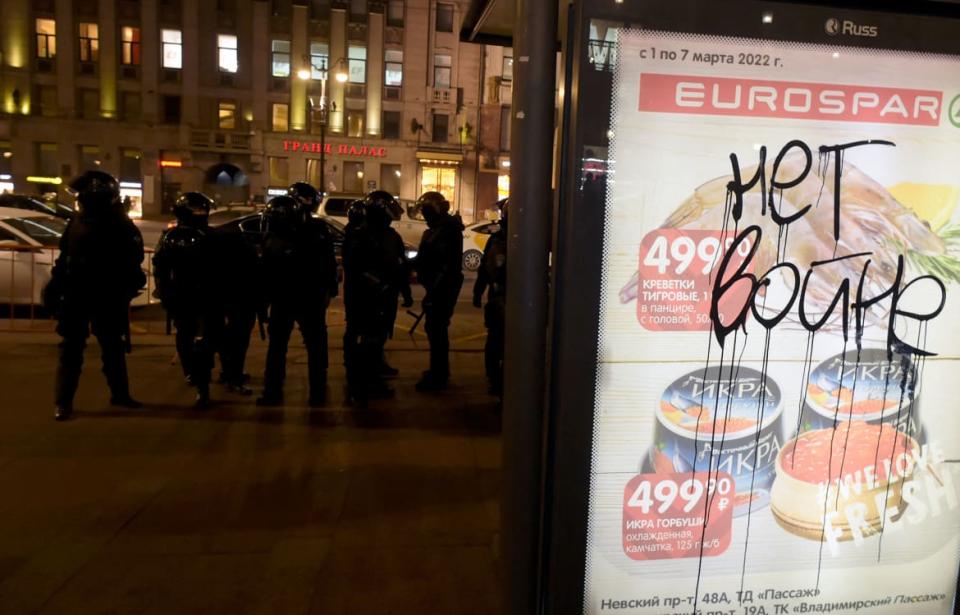 <div class="inline-image__caption"><p>An inscription reading “No to war” is seen on an advertisement board as riot police officers stand guard nearby during a protest against Russia’s invasion of Ukraine in central St. Petersburg on March 2.</p></div> <div class="inline-image__credit">Olga Maltseva/AFP via Getty</div>