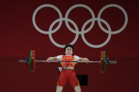 Hou Zhihui of China competes in the women's 49kg weightlifting event, at the 2020 Summer Olympics, Saturday, July 24, 2021, in Tokyo, Japan. (AP Photo/Luca Bruno)