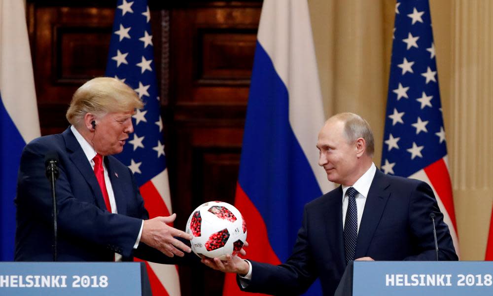 Donald Trump receives a football from Vladimir Putin after their meeting in Helsinki, Finland.