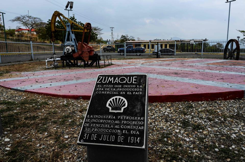 A plaque commemorates the beginning -on July 31, 1914- of oil production by the "Zumaque I" pumpjack in Mene Grande, Zulia state, Venezuela on March 15, 2019. - Production cutbacks by OPEC nations are building a supply cushion that could be called upon to mitigate a possible supply shock from an abrupt drop in crisis-hit Venezuela's output, the International Energy Agency (IEA) said Friday. (Photo by Juan BARRETO / AFP)        (Photo credit should read JUAN BARRETO/AFP/Getty Images)