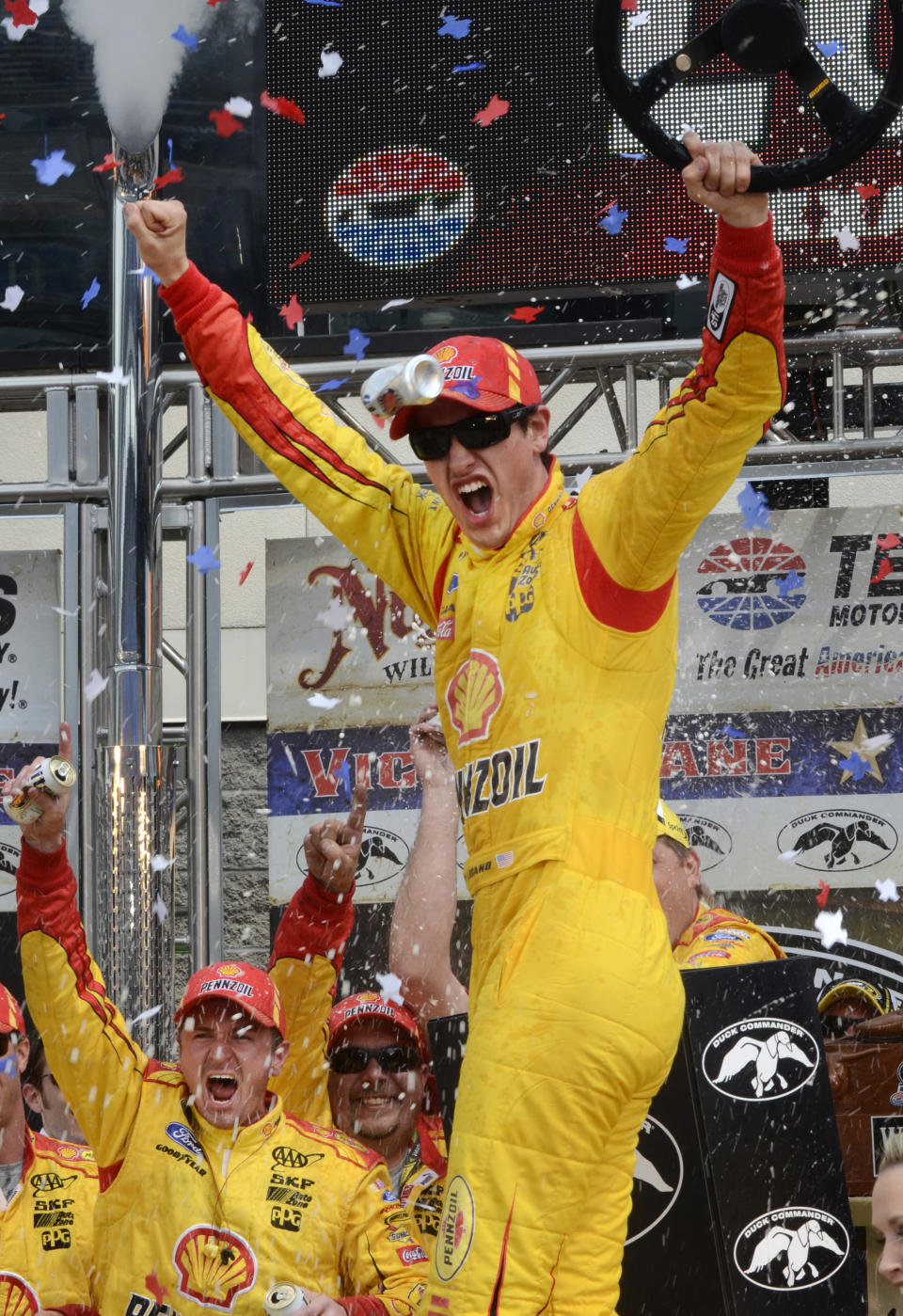 Joey Logano celebrates winning the NASCAR Sprint Cup Series auto race at Texas Motor Speedway Monday, April 7, 2014, in Fort Worth, Texas. (AP Photo/Larry Papke)