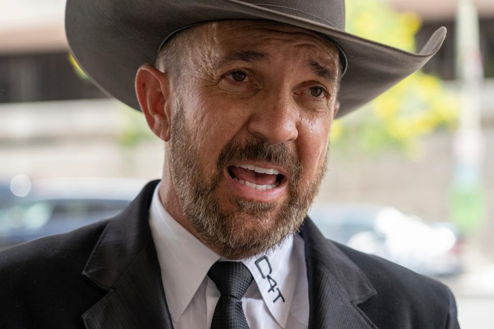 Otero County, New Mexico Commissioner Couy Griffin speaks to reporters as he arrives at the federal court in Washington, Friday, June. 17, 2022. Griffin, who is a central figure in a New Mexico county's refusal to certify recent election results based on debunked conspiracy theories about voting machines, has avoided more jail time for joining the mob that attacked the U.S. Capitol. He was sentenced to 14 days behind bars, which he has already served. (AP Photo/Gemunu Amarasinghe)