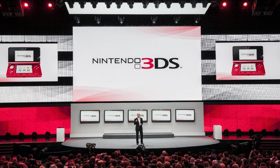 FILE - In this June 5, 2012 file photo, Scott Moffitt, executive vice president of sales and marketing for Nintendo of America, presents Nintendo 3DS at the Nintendo All-Access presentation at the E3 2012 in Los Angeles. The gaming company said Tuesday, May 6, 2014, it wouldn't bow to pressure to allow players to engage in romantic entanglements with characters of the same sex in the English version of "Tomodachi Life" following a social media campaign launched last month seeking virtual equality for the game's characters, which are modeled after real people. (AP Photo/Damian Dovarganes, file)